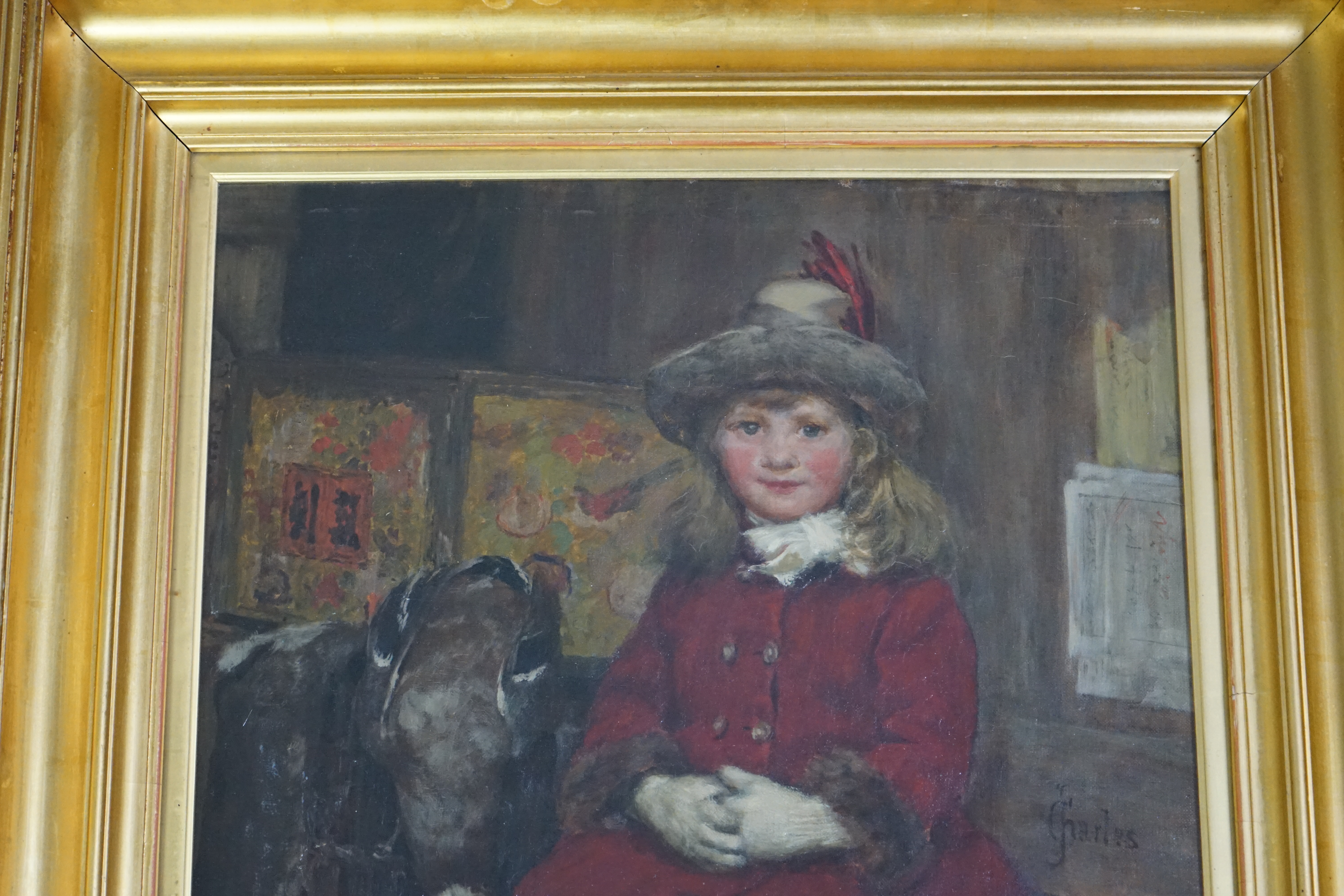 James Charles (British, 1851-1906), Seated child in a red coat, oil on canvas, 56 x 43cm